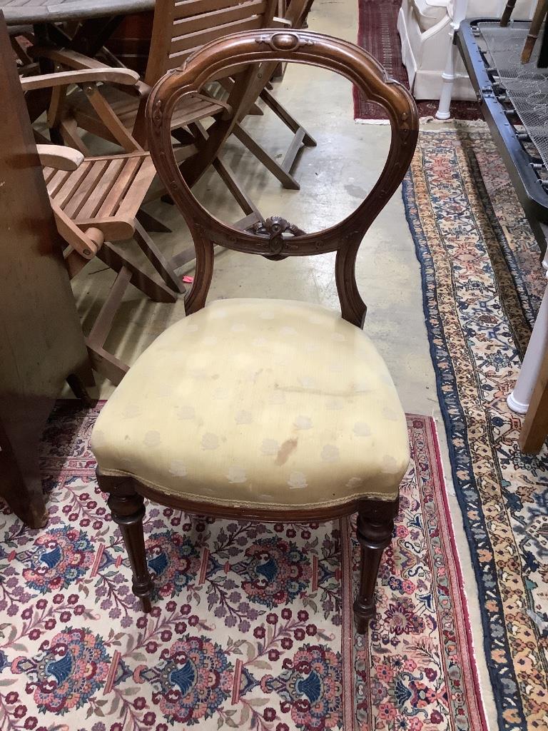 A set of six Victorian carved walnut balloon back dining chairs